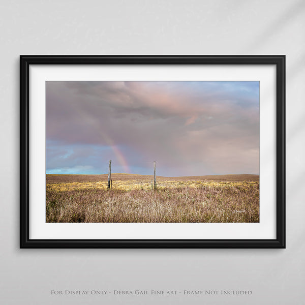 a framed photograph of a rainbow in the distance