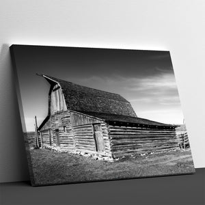Black and white canvas of historic Mormon Row barn in Wyoming with dramatic sky and rustic wooden architecture.