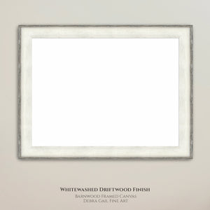 a white wooden frame with a blank canvas inside, hanging on a wall.