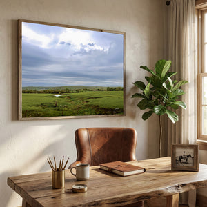 A Flint Hills Kansas framed fine art print depicting a beautiful green field under a cloudy sky, by Debra Gail.